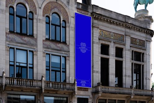 Urban billboard mockup mounted on a classic building facade for advertising and branding presentation, edit-ready for designers and creative visuals.